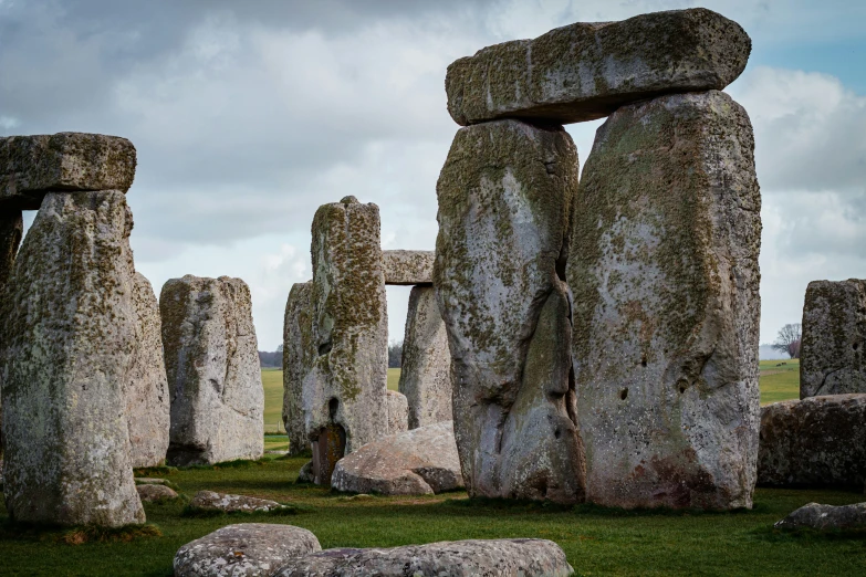 a large group of rocks sitting in the middle of a field