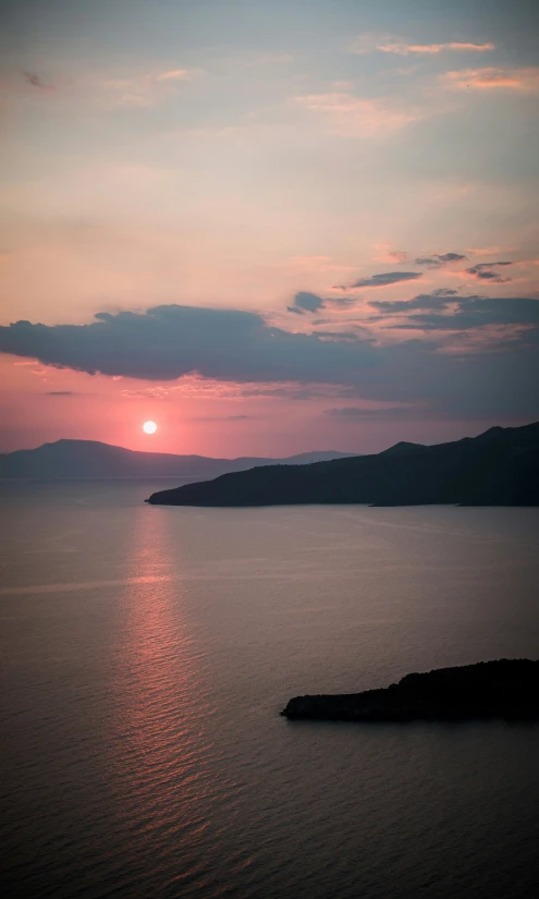 a view of a calm ocean at sunset