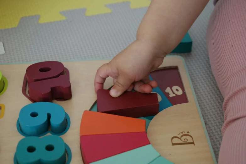 a child is using magnets on an infant activity board