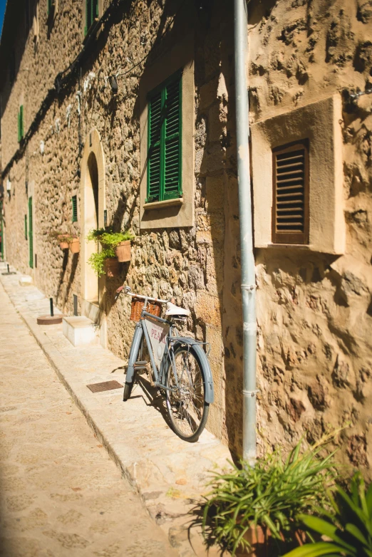 a bicycle is parked in front of a stone building