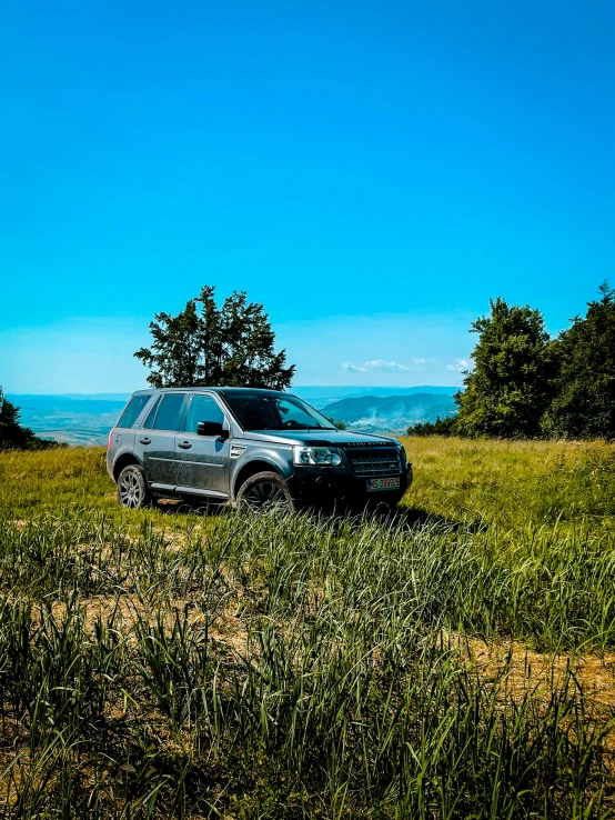 an suv that is parked in some grass