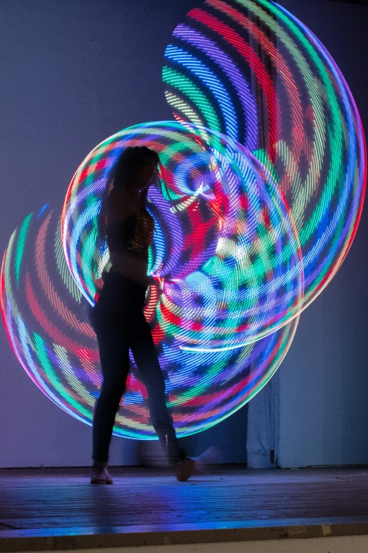 woman in front of a colorful light painting