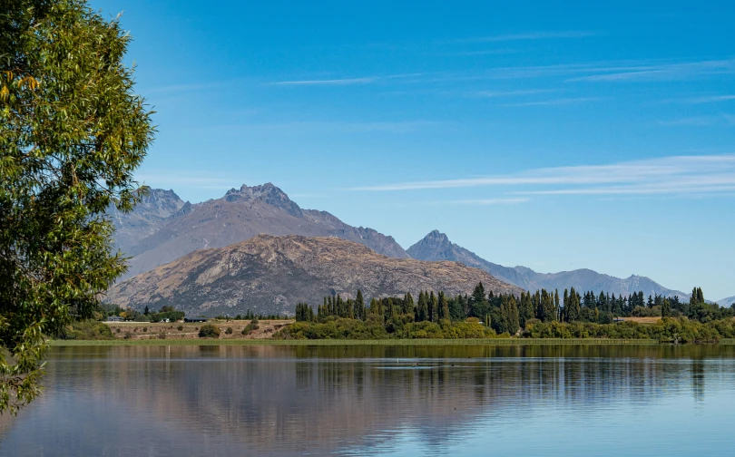 the water is placid and the mountains are in view