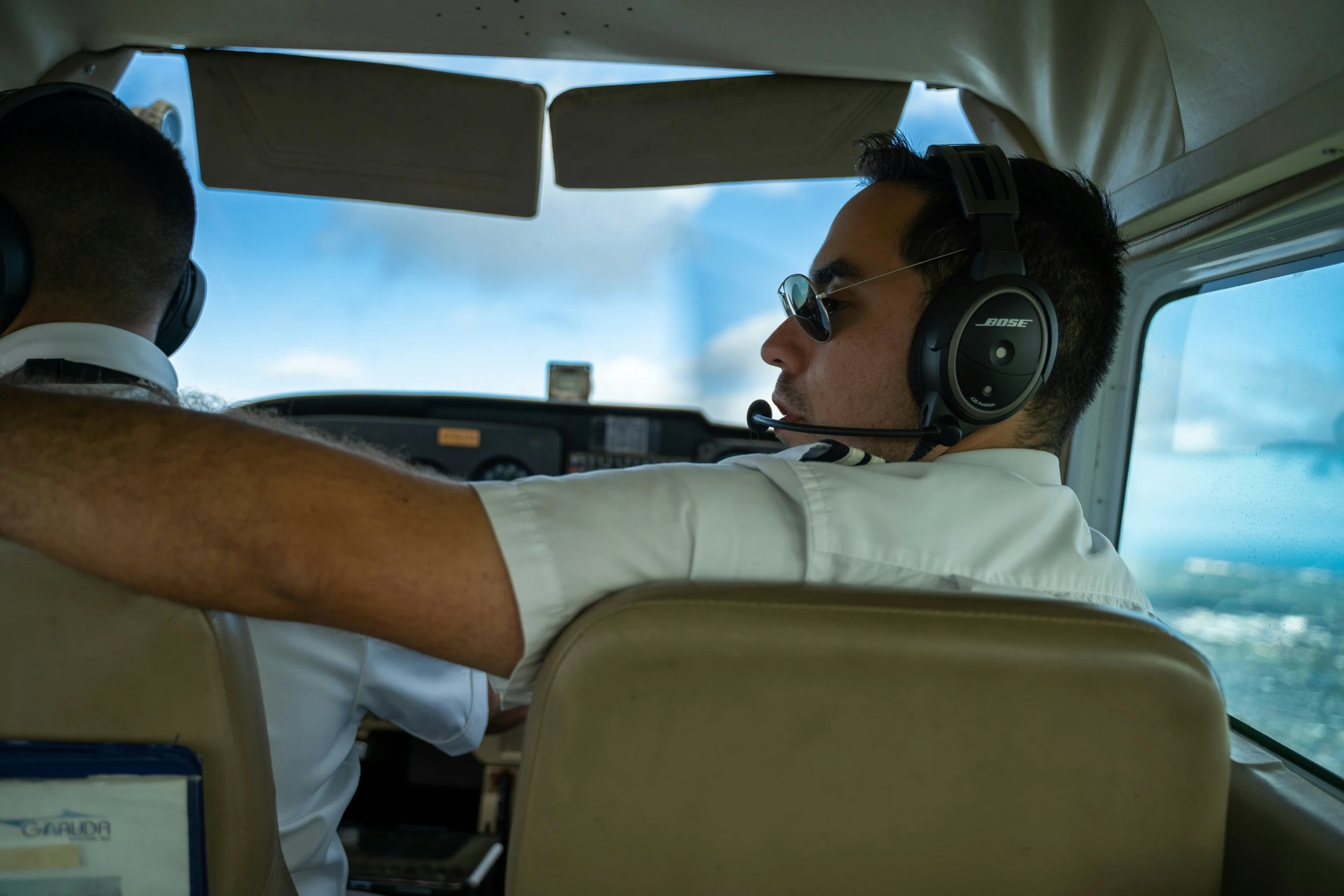 a pilot is sitting in the cockpit as he watches his planes flight