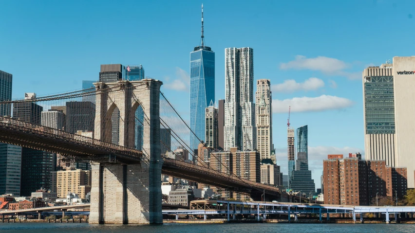 a bridge over a river filled with lots of tall buildings