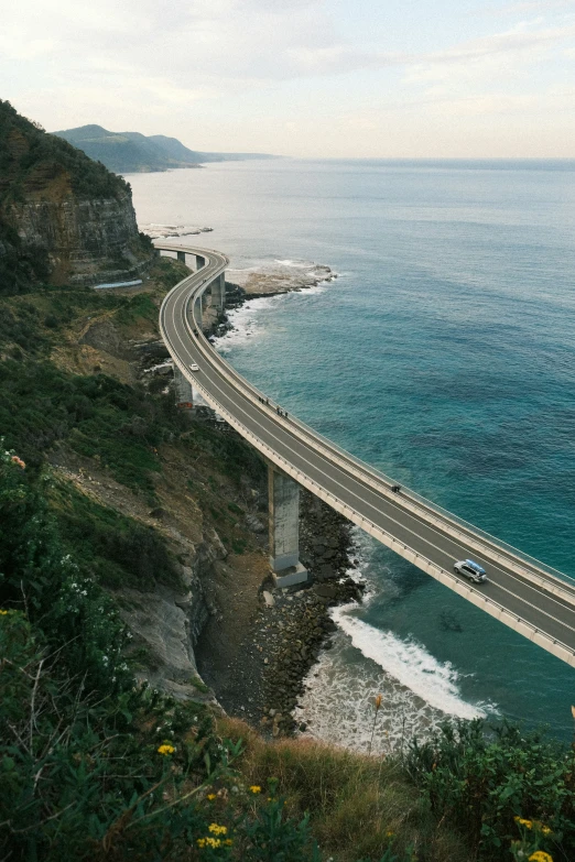 a highway on a steep hillside with water on both sides