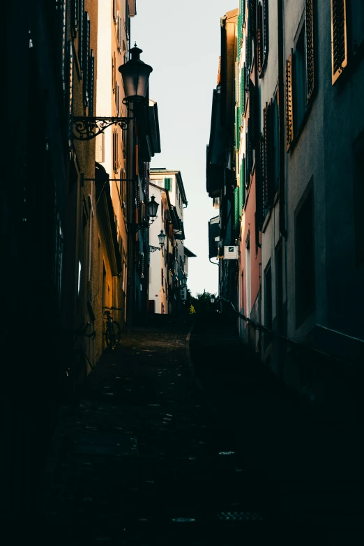 an alley way with traffic lights and old buildings