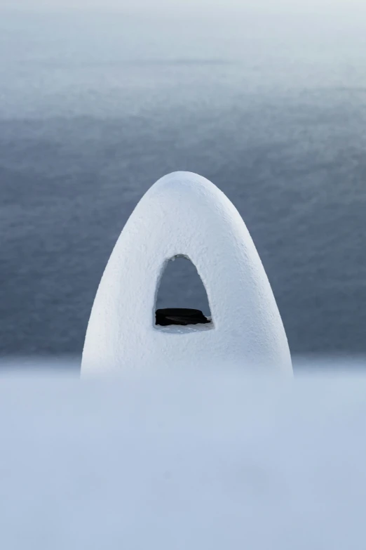 an ice cave with water in the background