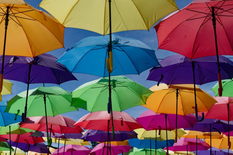 brightly colored umbrellas are spread out in the sky