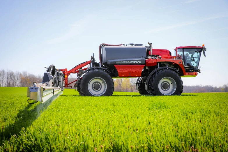 a red tractor is shown sitting in a field