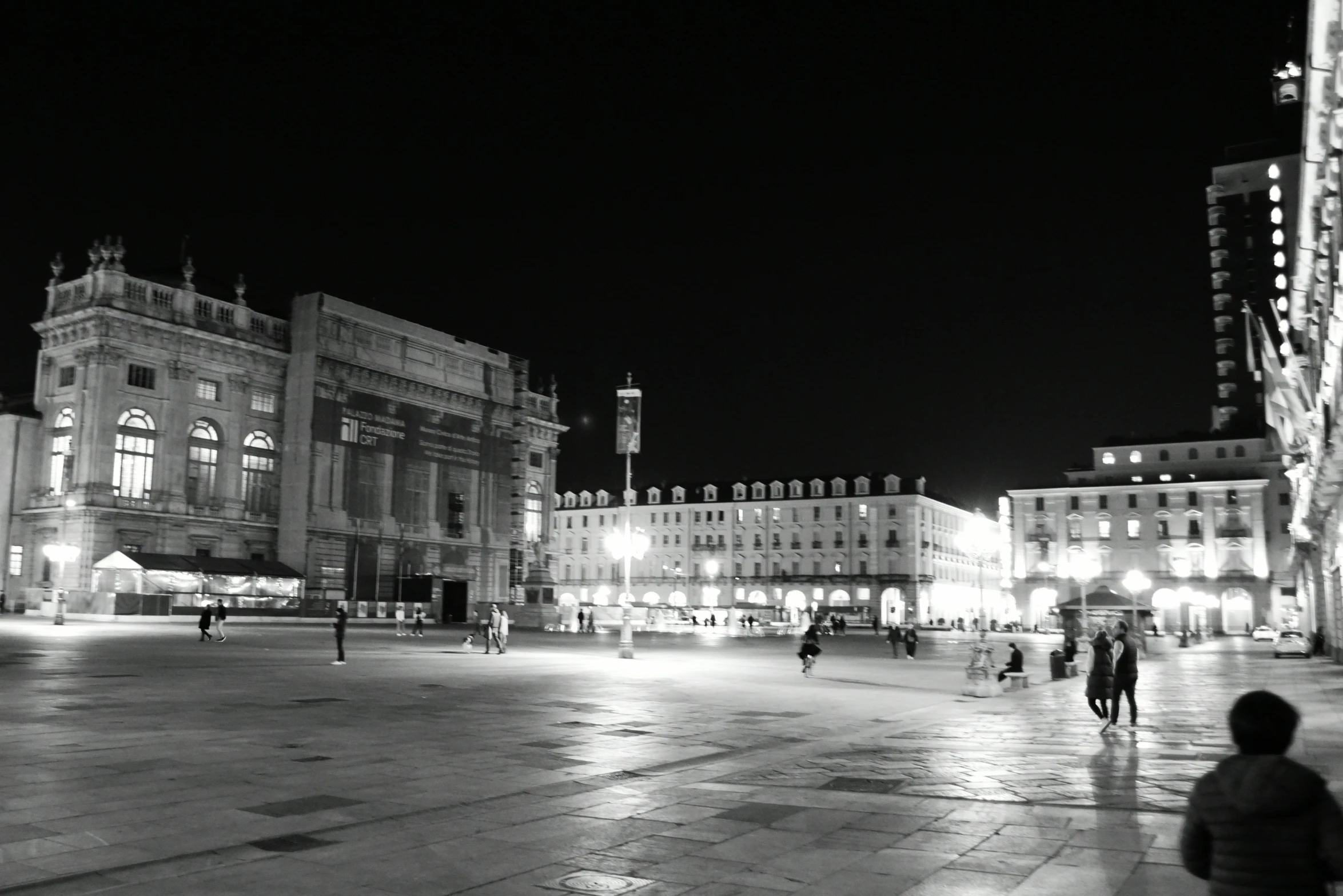 a black and white po of a city square at night