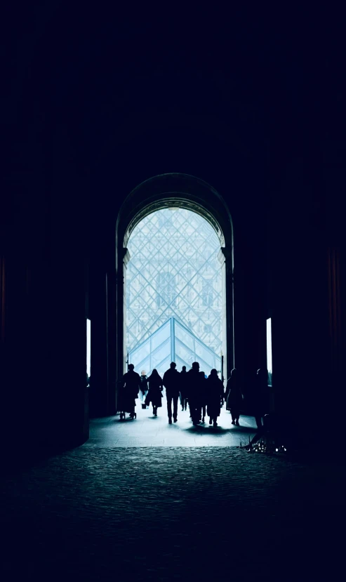 a group of people walking out of an open door