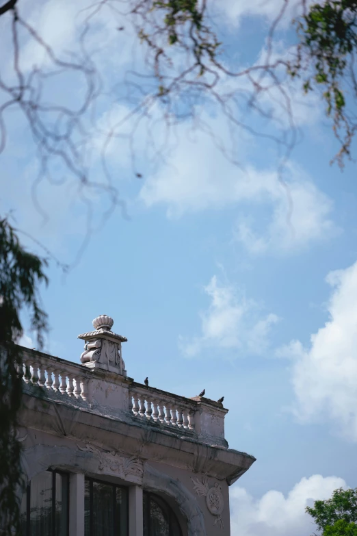 a building with a decorative top and large windows