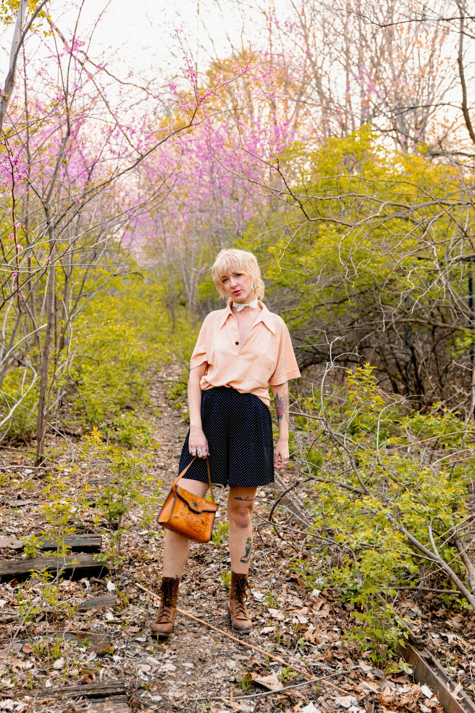 an elderly woman in the woods posing for a pograph