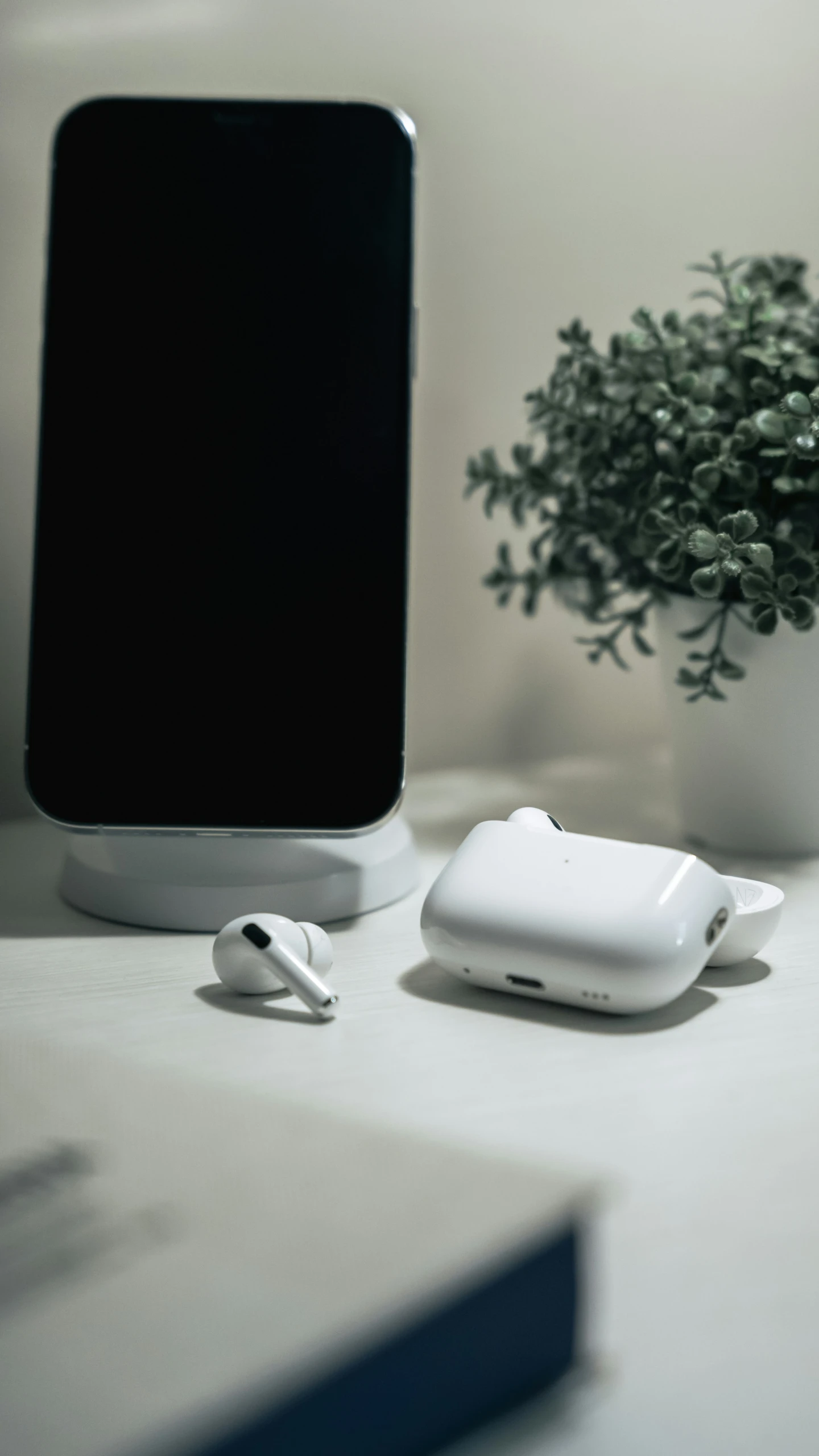 an assortment of items that include a charger, air pods and a cell phone