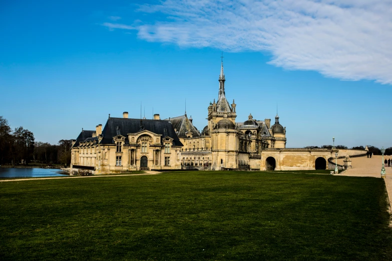 a large castle on the grass on a sunny day