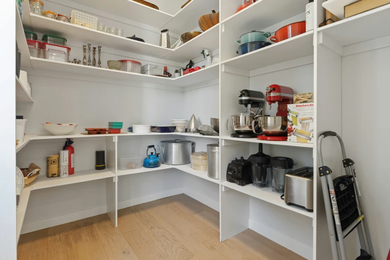 a white pantry filled with lots of cooking items