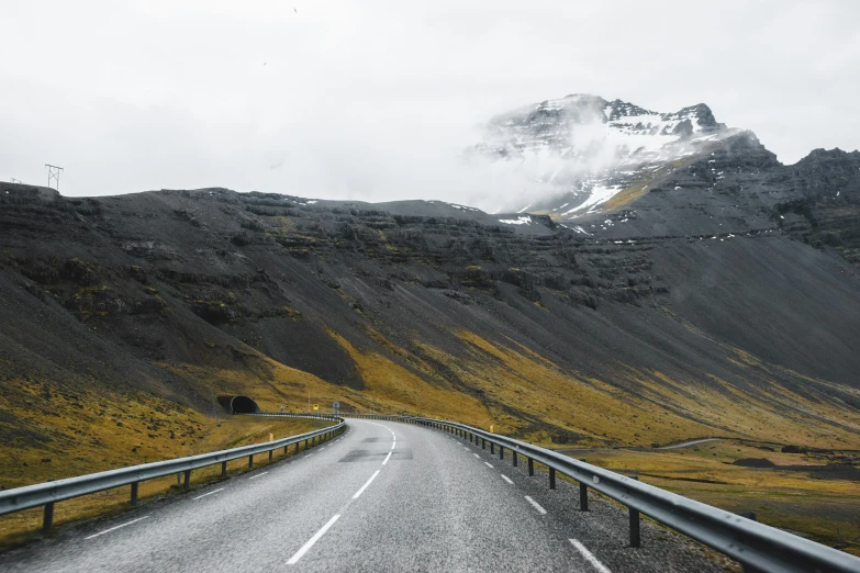 a mountain road surrounded by rocks in the wilderness