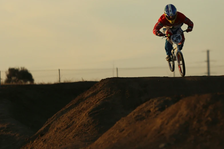 a dirt biker does a jump on his bike