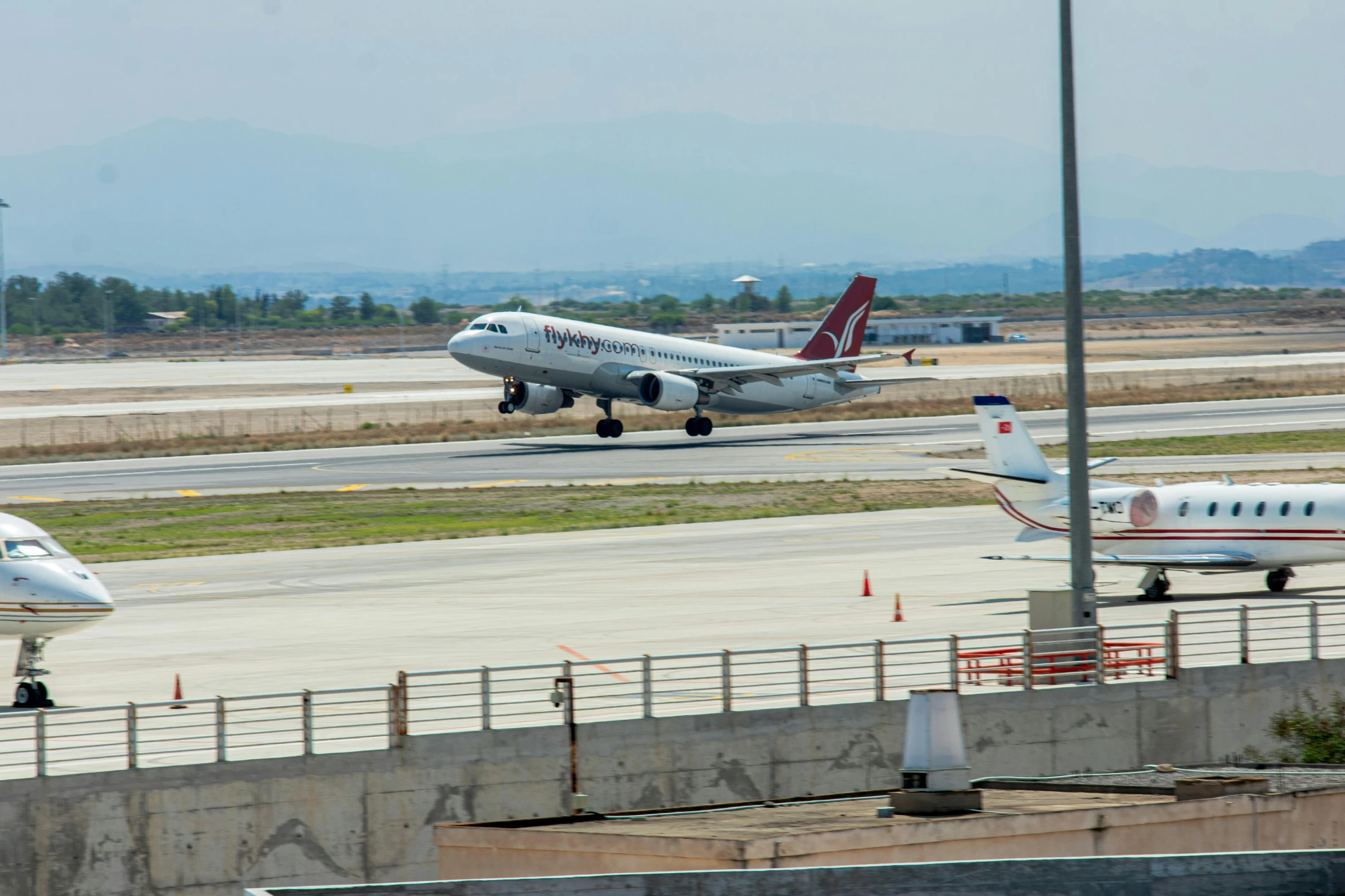 three airplanes on the runway near one another