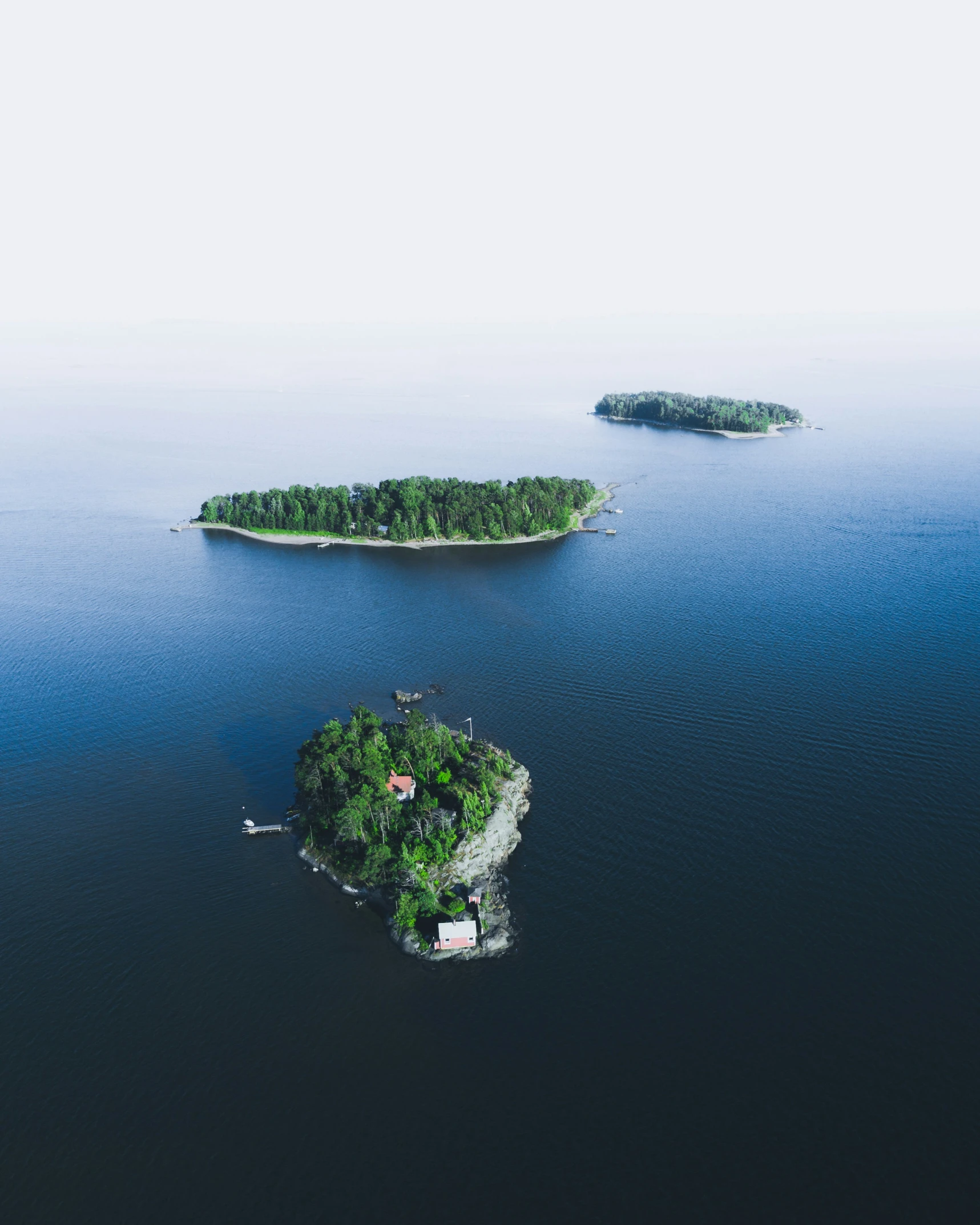 two island shaped landforms sit in a large lake