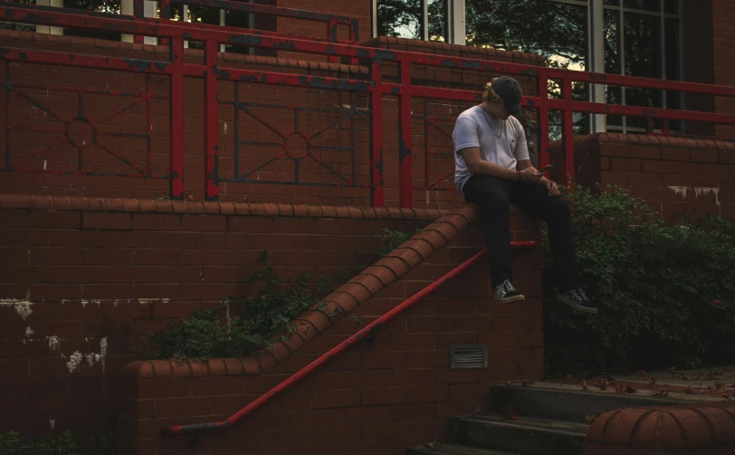a person on a skateboard sits down some stairs