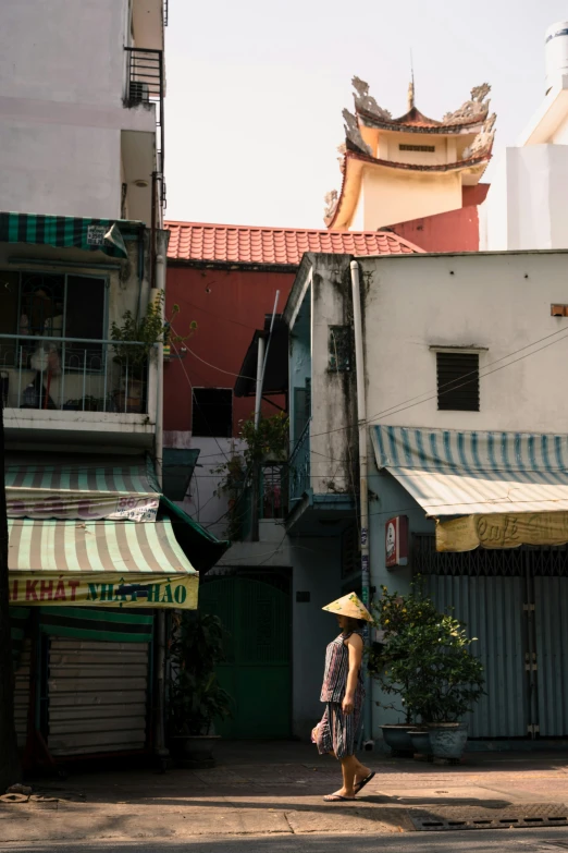 a person with a yellow hat is walking through the street