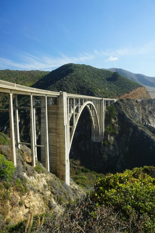 a tall bridge that is on the side of a mountain