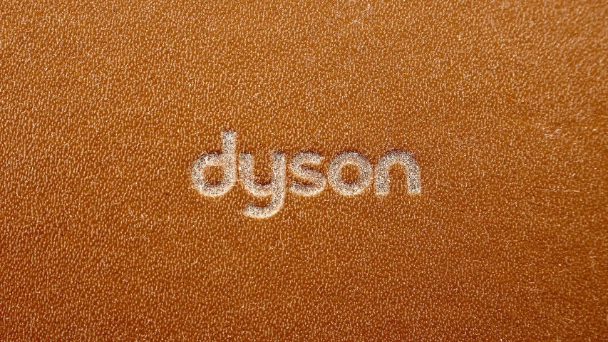 a brown leather surface with the word dust on it