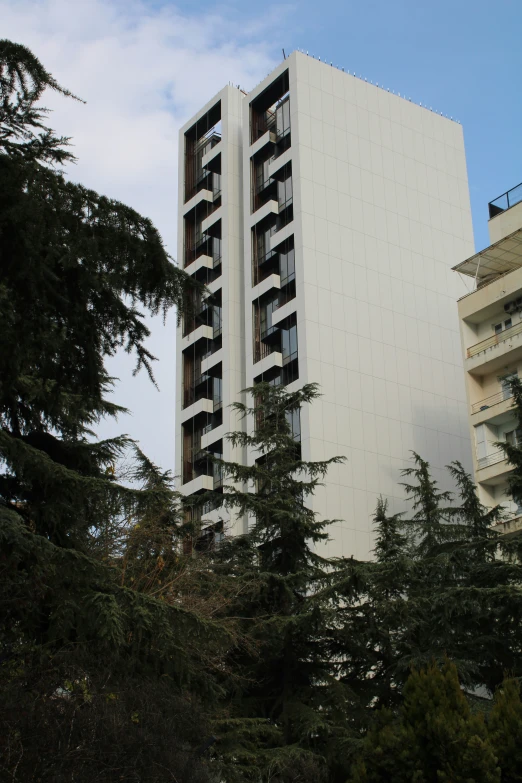 an apartment building in the city with a car parking lot below