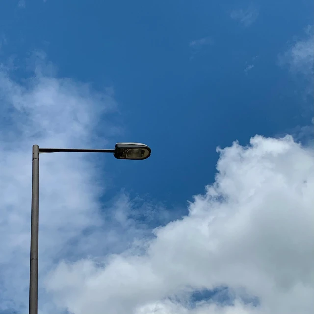 a street light and a lamp pole in the distance