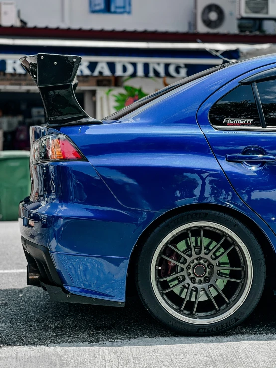 a blue sedan parked in front of a building