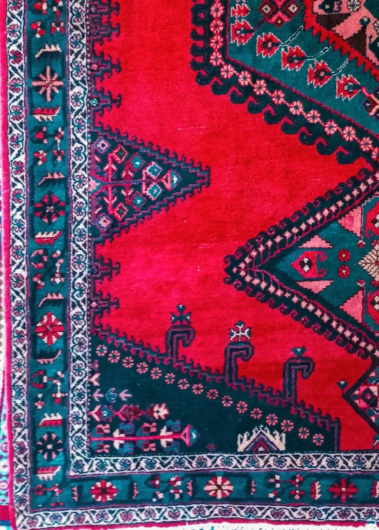 an old handmade rug with colorful design