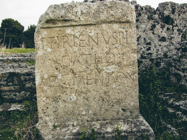 a grave in an old graveyard with writing on it