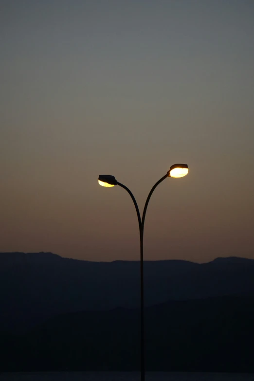 an image of street lamp at dusk on the sea