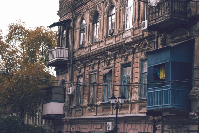 a building with an awning and a clock on the corner