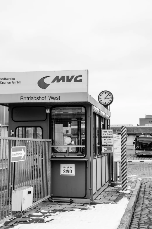 the bus stop has a metal fence around it