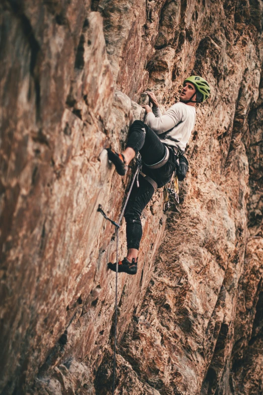 a man climbing on a large rocky wall