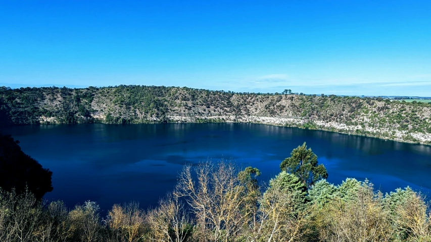 a large pond surrounded by trees and water