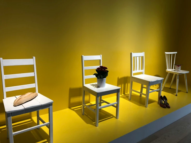 two chairs and two wooden chairs with yellow walls