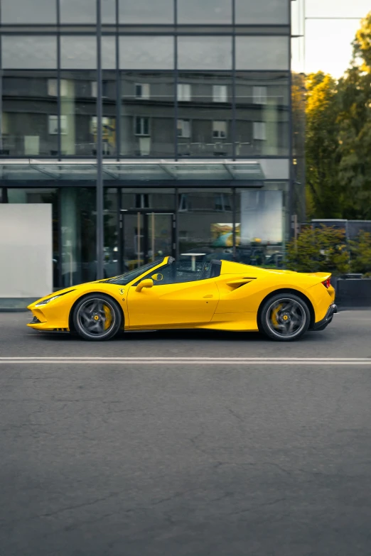 yellow sports car in front of a building