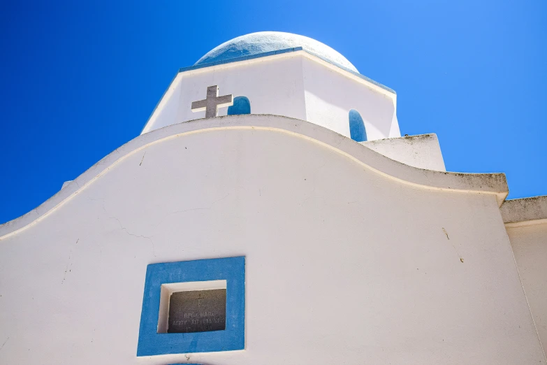 the cross is above the church building's window