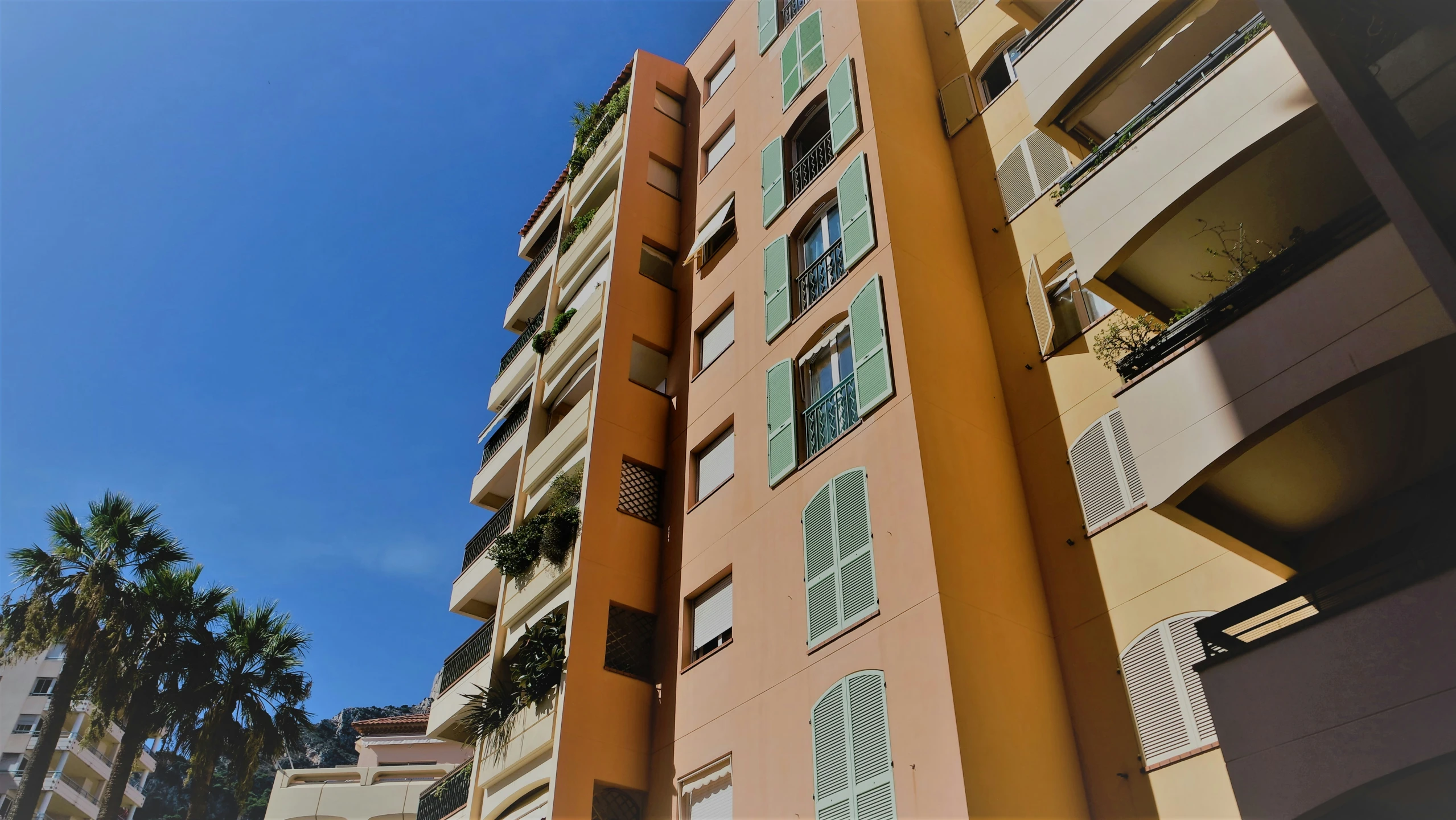 a tall building with many windows and shutters on it