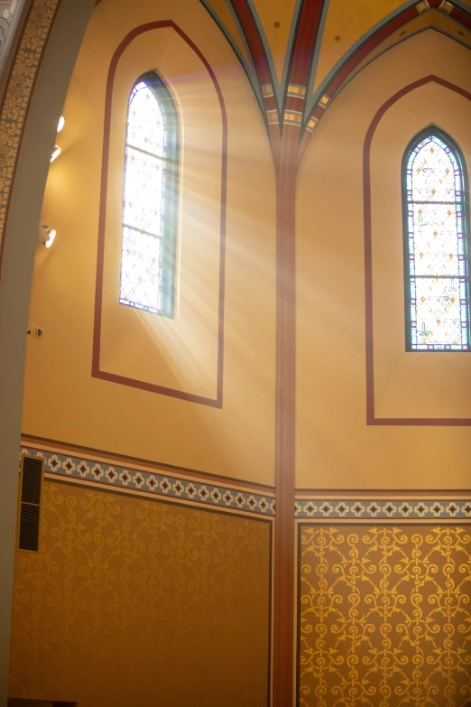 the sunlight streaming through the window of a church