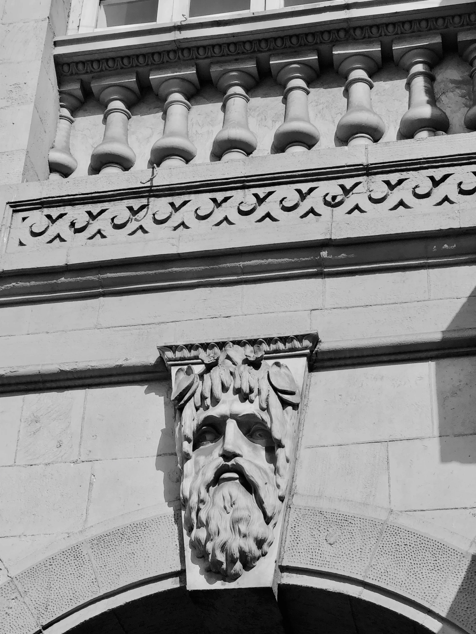 a statue of a man with a beard on the front of a building