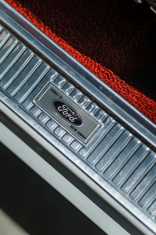 the back badge of an automobile that is red and silver