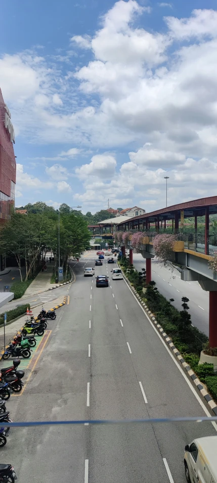 a busy street that has a few cars on the side