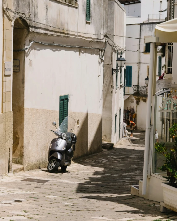 a scooter parked on the side of a city street