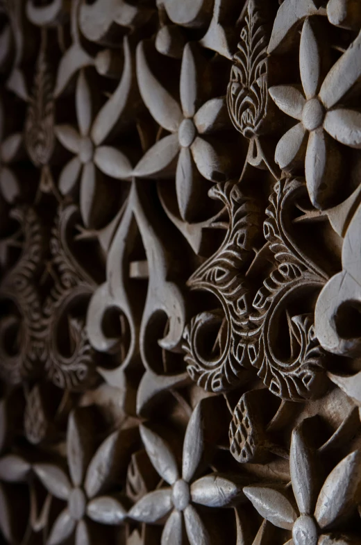 carvings on a wall depicting flowers and a decorative flower