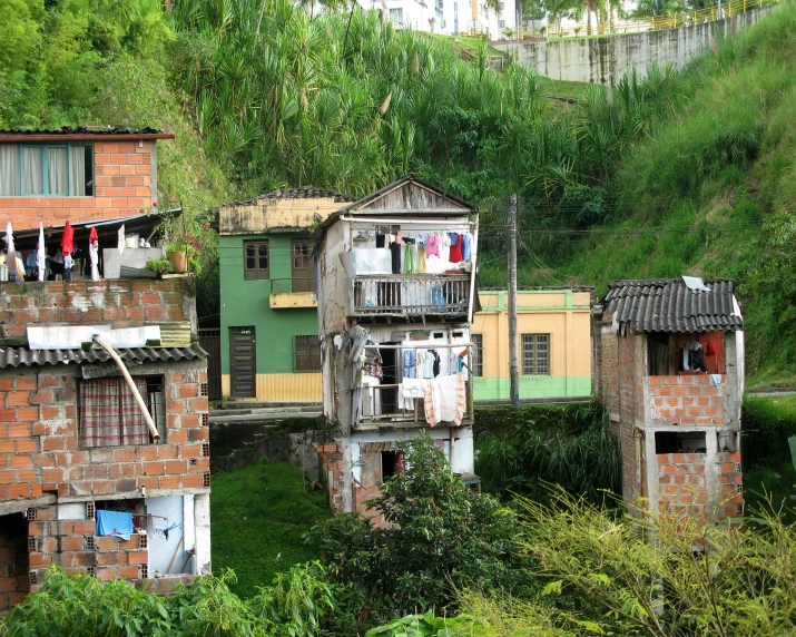 some people are hanging out the balcony of many old homes